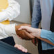 Hands shaking between two people